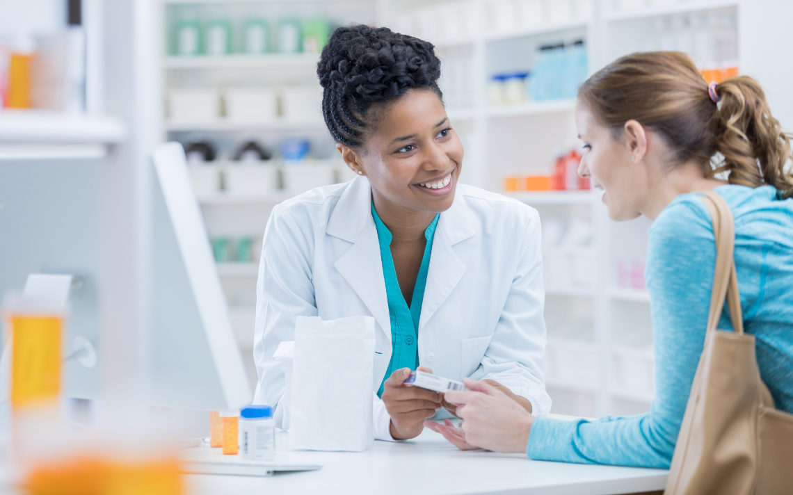 Woman pharmacist serving woman customer